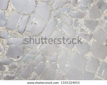 Detail of old medieval pavement / Block stone road / Broken stone pavement / Vintage background, abstract texture and material of an ancient.