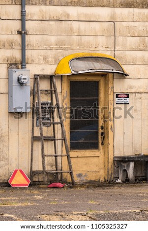 Old Grungy Wooden Building Entrance Door, Ladder, Electricity Power Usage Meter and Warning sign for Man Cave.