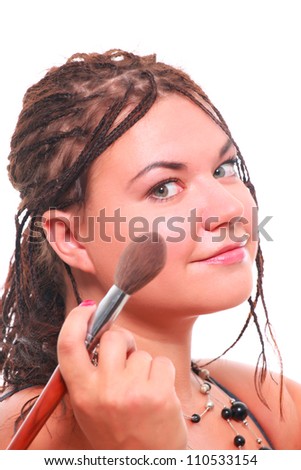 Makeup. Studio shot of attractive young woman applying cosmetics to her face. Picture taken against pure white background