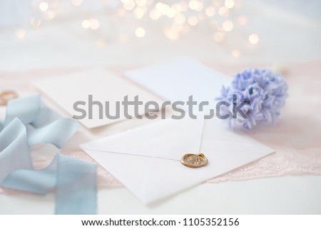 wedding invitation card as a decorated letter with blurred lights on background bokeh