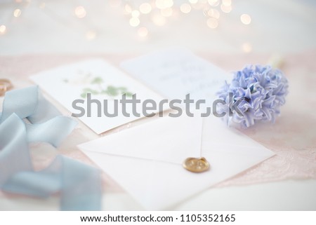 wedding invitation card as a decorated letter with blurred lights on background bokeh