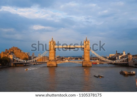 Tower bridge in London, United Kingdom. Bridge over Thames river on cloudy sky. Buildings on river banks with nice architecture. Structure and design. Wanderlust and vacation concept.