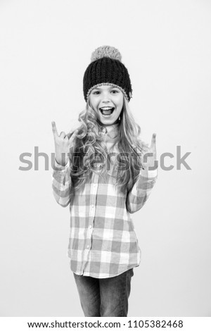 Fashion, wow style trend. Child with long blond hair smile with horn hands. Beauty look hairstyle. Girl in hat, plaid shirt on orange background. Happy childhood concept.