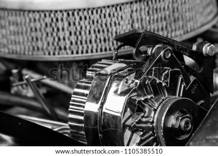 Monochrome picture of vintage car engine featuring different engine components