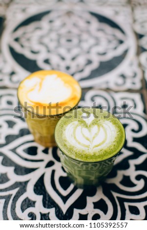 Trendy multicolored lattes. Avocado and turmeric tastes with latte art.