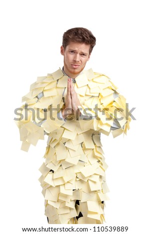 The young man covered with yellow sticky notes, isolated on white background