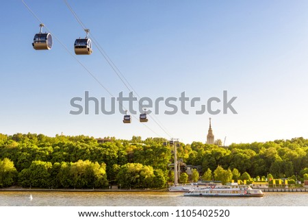 Beautiful panorama of Moscow, Russia. Scenic view of the cable car between Sparrow Hills and Luzhniki Stadium in Moscow. Cableway cabins hang in the sky over Moskva River at Moscow Luzhniki park. Royalty-Free Stock Photo #1105402520