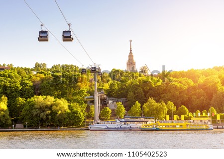 Panorama of Moscow in sun light, Russia. Scenic view of the cable car between Sparrow Hills and Luzhniki Stadium in summer Moscow. Cableway cabins hang over Moskva River at Moscow Luzhniki park. Royalty-Free Stock Photo #1105402523