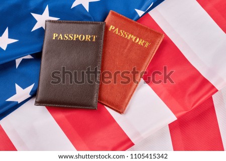 Close up two passports on American flag. Personal documents on USA flag background, horizontal image. Citizenship of America.