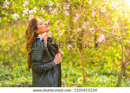 The girl in the flowers of the magnolia