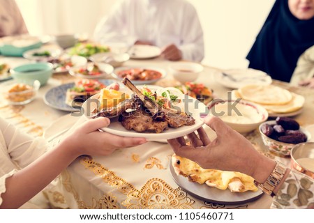 Muslim family having a Ramadan feast Royalty-Free Stock Photo #1105460771