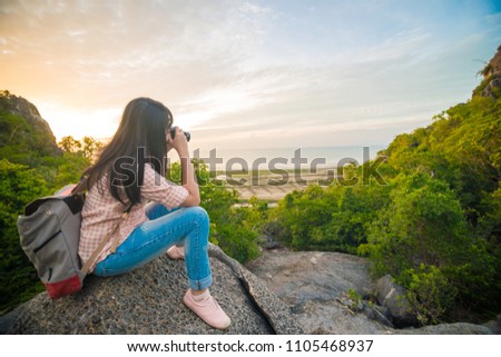 Backpacks Photographer women enjoying sunrise on mountain,Nature landscape