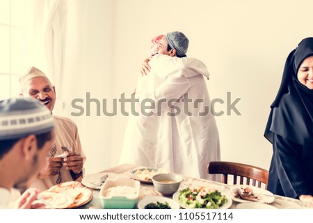 Muslim men hugging at lunchtime Royalty-Free Stock Photo #1105517114