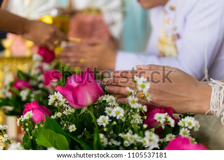 Thai traditional wedding ceremony, water-pouring ceremony on bride's hands, love and wedding concept.