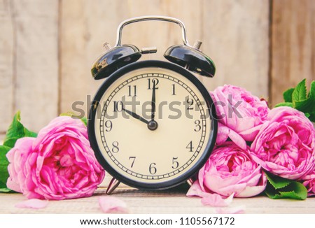 Alarm clock 10 hours. Flowers. Selective focus. 