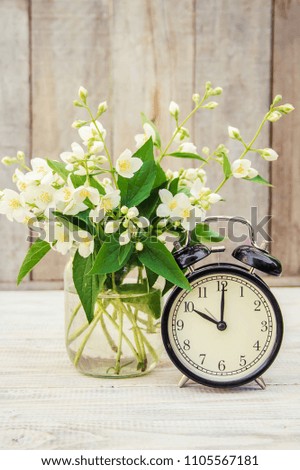 Alarm clock 10 hours. Flowers. Selective focus. 