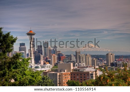 A daytime view of downtown Seattle and the Space Needle with Mt. Ranier in the background.