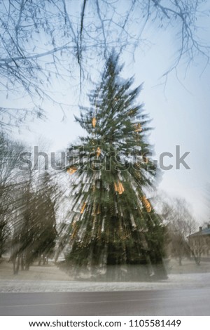 Christmas abstract background. Defocused christmas tree with motion light. Zoom burst photography. 