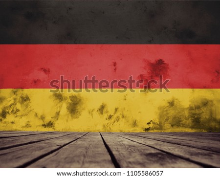 The floor  of planks and plastered wall with a painted Germany flag.