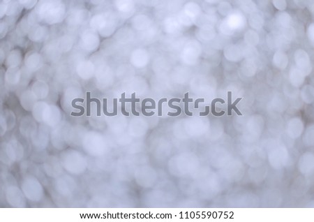 Silver sparkling lights. Glitter festive texture. Abstract background Christmas. Bokeh and stars. Winter card or invitation.