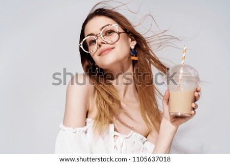   woman in glasses with a drink of coffee                             