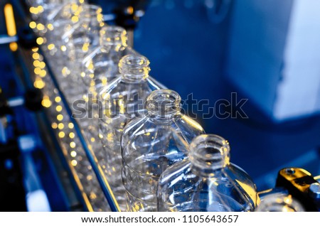 Bottle. Industrial production of plastic pet bottles. Factory line for manufacturing polyethylene bottles. Transparent food packaging. Royalty-Free Stock Photo #1105643657