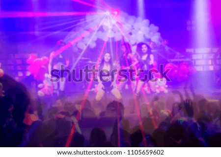 blurred light in night club party festival with crowd of people for background;