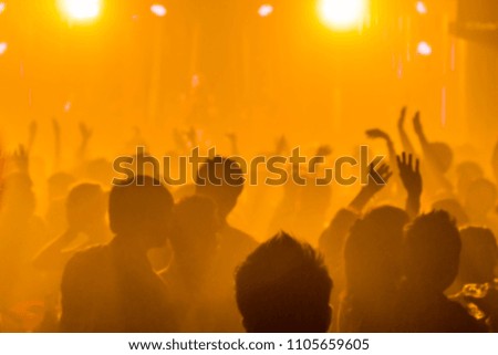 blurred light in night club party festival with crowd of people for background;