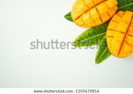 Fresh and beautiful mango fruit with sliced diced mango chunks on a light blue background, copy space(text space), blank for text, top view, topview, copyspace, closeup Royalty-Free Stock Photo #1105670816