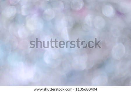 Silver sparkling lights. Glitter festive texture. Abstract background Christmas. Bokeh and stars. Winter card or invitation.