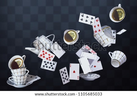 Wonderland background. Mad tea party. Cups, teapot and playing cards falling down the rabbit hole.