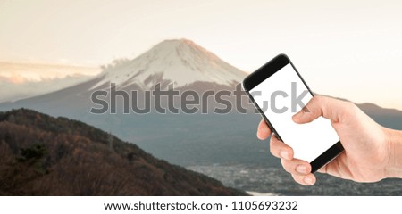 Touch screen in hand take a photo fuji mountain. Travel concept.