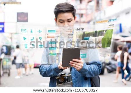 Asian tourist backpacker using mobile appication technology booking hotel online while traveling on vacations,  selective focus