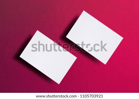 Mock up of two horizontal white business cards at pink textured paper background. Mock-up template for branding identity. For graphic designers presentations and portfolios