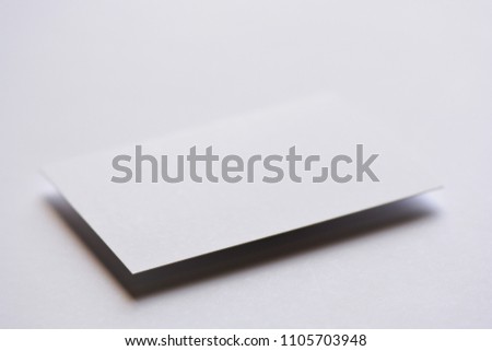 Photo of blank white business cards on white. Mock-up for branding identity. For graphic designers presentations and portfolios