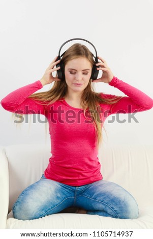 Happy girl listening to music. Young lady wearing headphones. Leisure lifestyle relax concept. 
