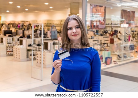 Woman going shopping with credit card in mall