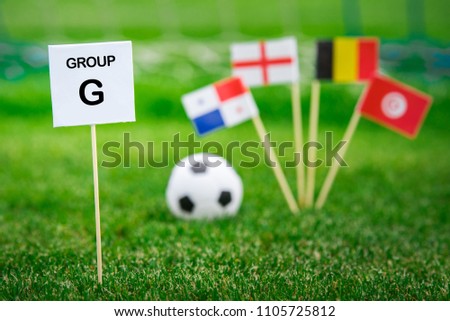 Group G - National flags of Belgium, Panama, Tunisia, England in Russia. Table with title "Group G" National flags in background Royalty-Free Stock Photo #1105725812
