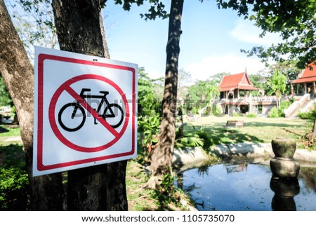 No cycling sign hanging on a trees in a park.  Sign indicating the prohibition or rule. Warning and forbidden.