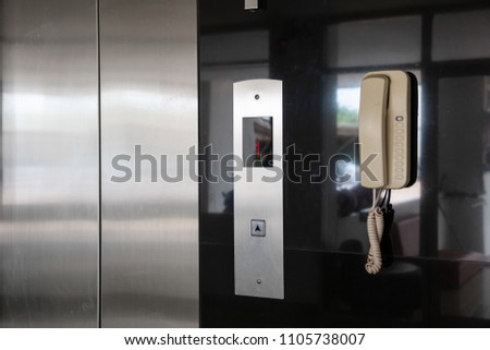 Up Arrow metal button's elevator.first floor display on panel.Elevator Conveying Transportation Concept of Elevator Arrow in Lobby Area.