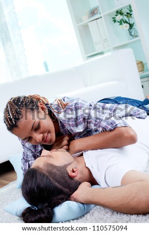 Image of young guy and his girlfriend relaxing at home
