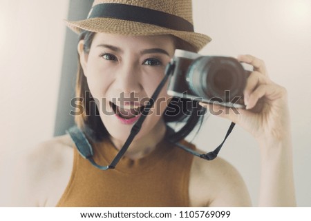 travel and vacation ideas concept with beautiful asian woman take photo with happiness and joyful white room background