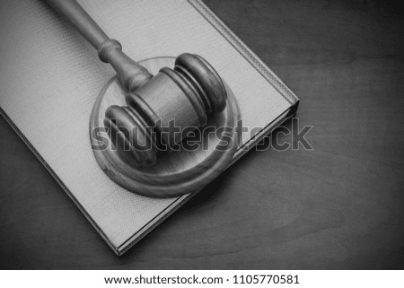 Wooden judge gavel on book, legal concept