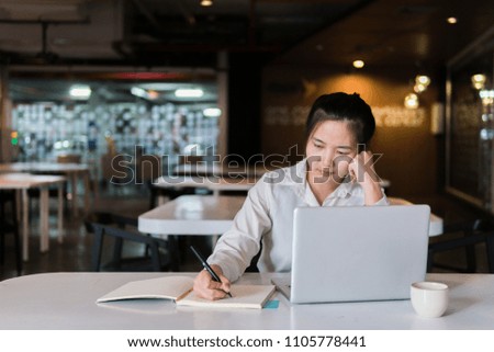 Serious beautiful woman using notebook computer and hand touching face to thinking new ideas for new business project plan. Businesswoman working on laptop and creating new idea strategy at desk.