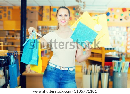 Smiling woman buys packages for gifts in a store