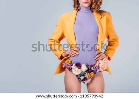 cropped shot of girl in panties made of flowers standing with hands on waist isolated on grey