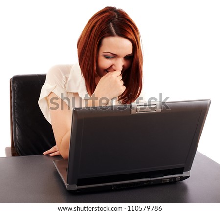 Young woman at her computer, laughing about what's on the screen