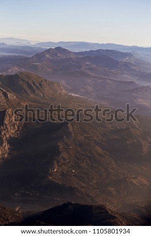 Misty dawn, an in-flight shot of the Montes de Malaga, Andalucia, Spain.