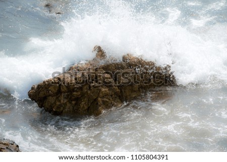 Sea wave attack rock. Splashing wave