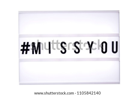 Miss you text in a light box. Box isolated over white background. A sign with a message
